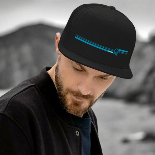 Man wearing a black cap with a blue design on a light gray background